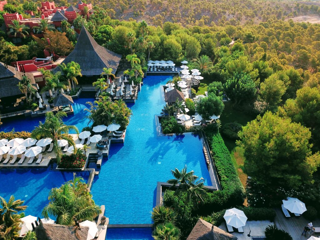 Aerial view of the infinity pool at Asia Gardens Hotel & Thai Spa surrounded by tropical gardens