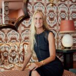 Cristina Lozano, founder of Cristine Bedfor, seated in the vibrant lounge of Casa Cristina Sevilla.